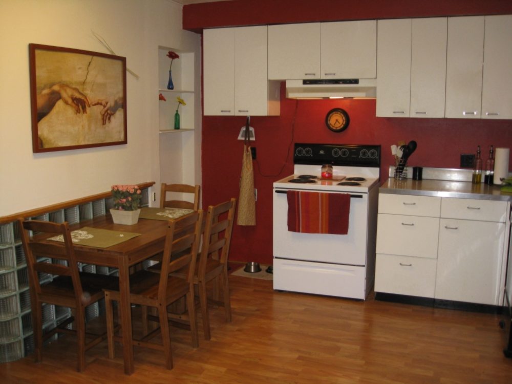 Red kitchen with white cupboards